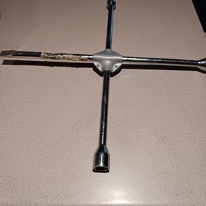 4 sided lug wrench  3/4 ", 7/8"  13/16" and tire iron pry bar end  IF used -1 x